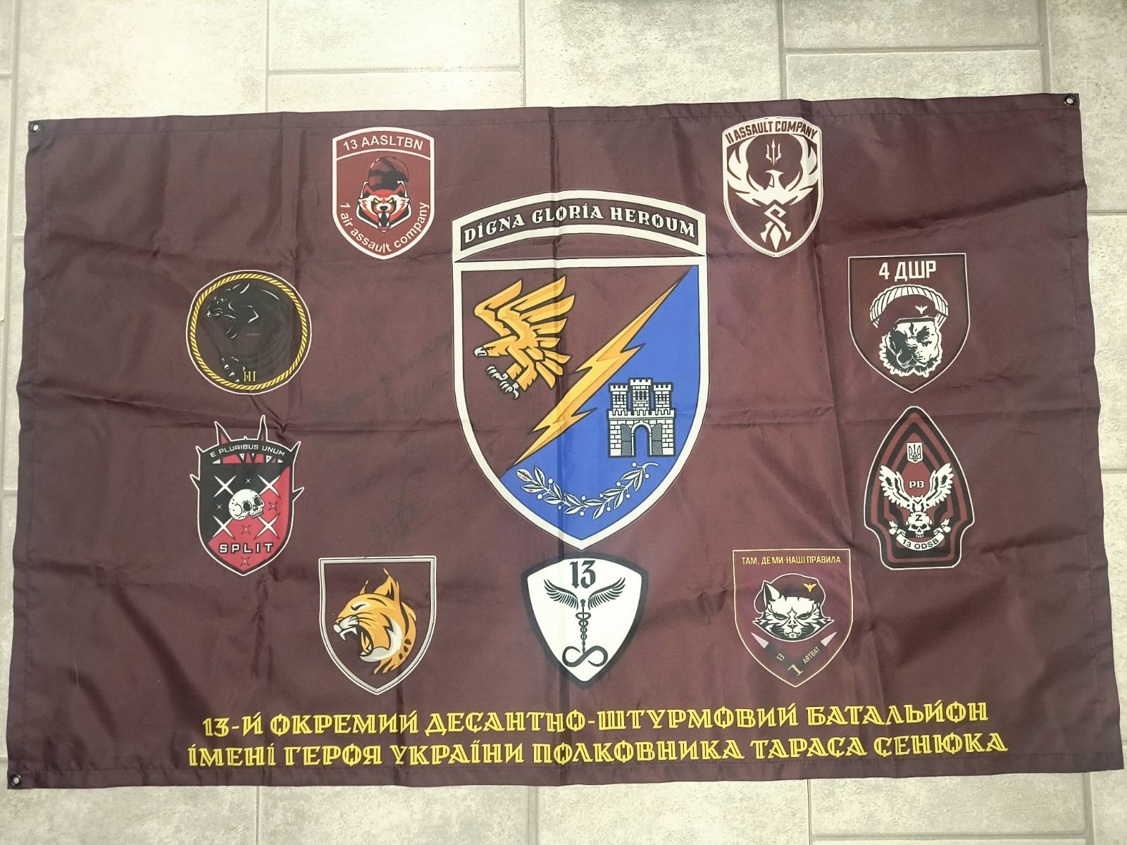 Ukrainian flag signed by fighters of 13th Airmobile Battalion